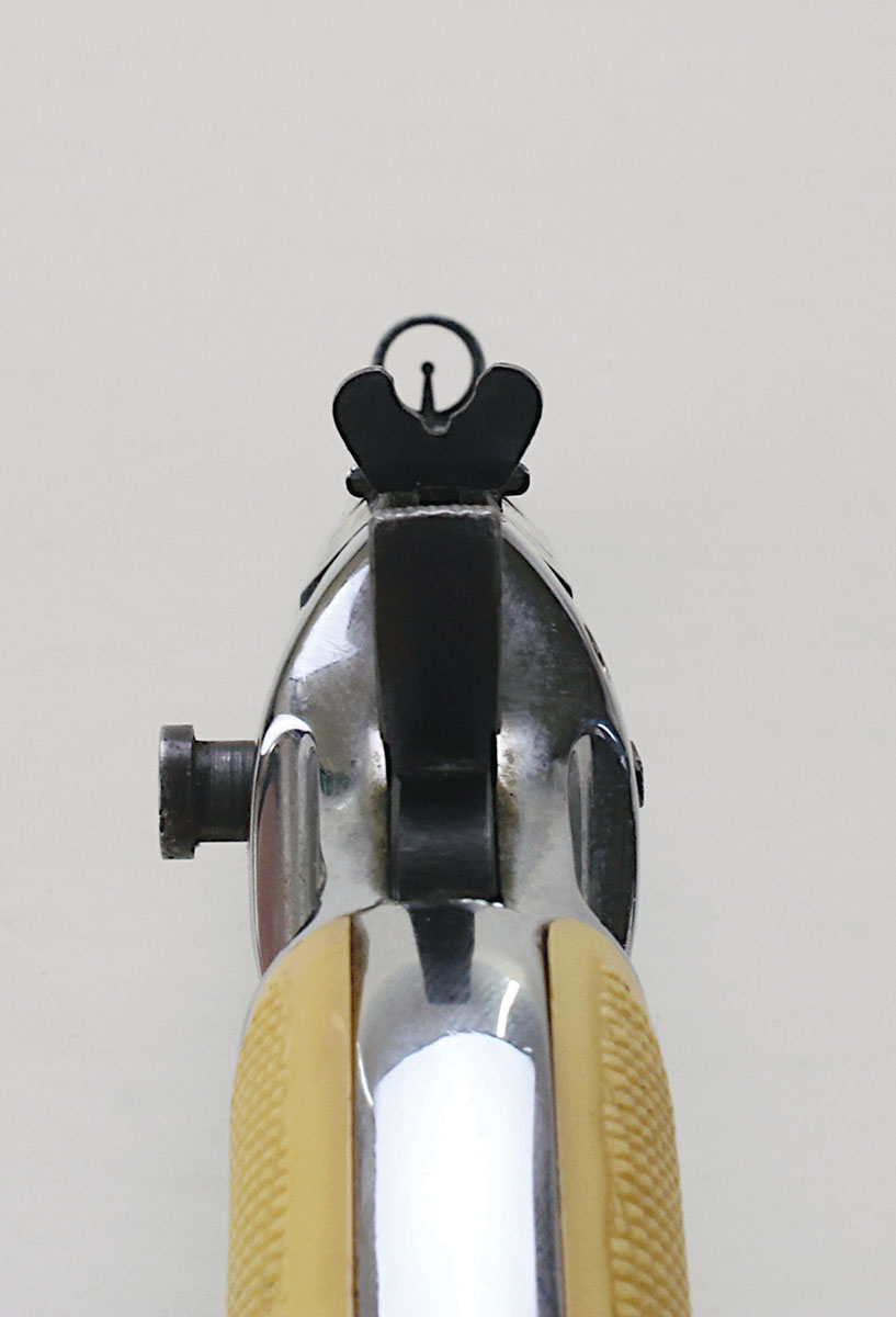 Front and rear sights look like those found on older rifles. The protrusion on the left side is  the spring-loaded barrel lock; pushing inward  unlocks the barrel.